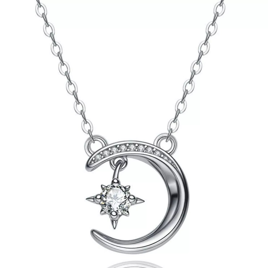 Silver necklace with a crescent moon and star pendant on a white background