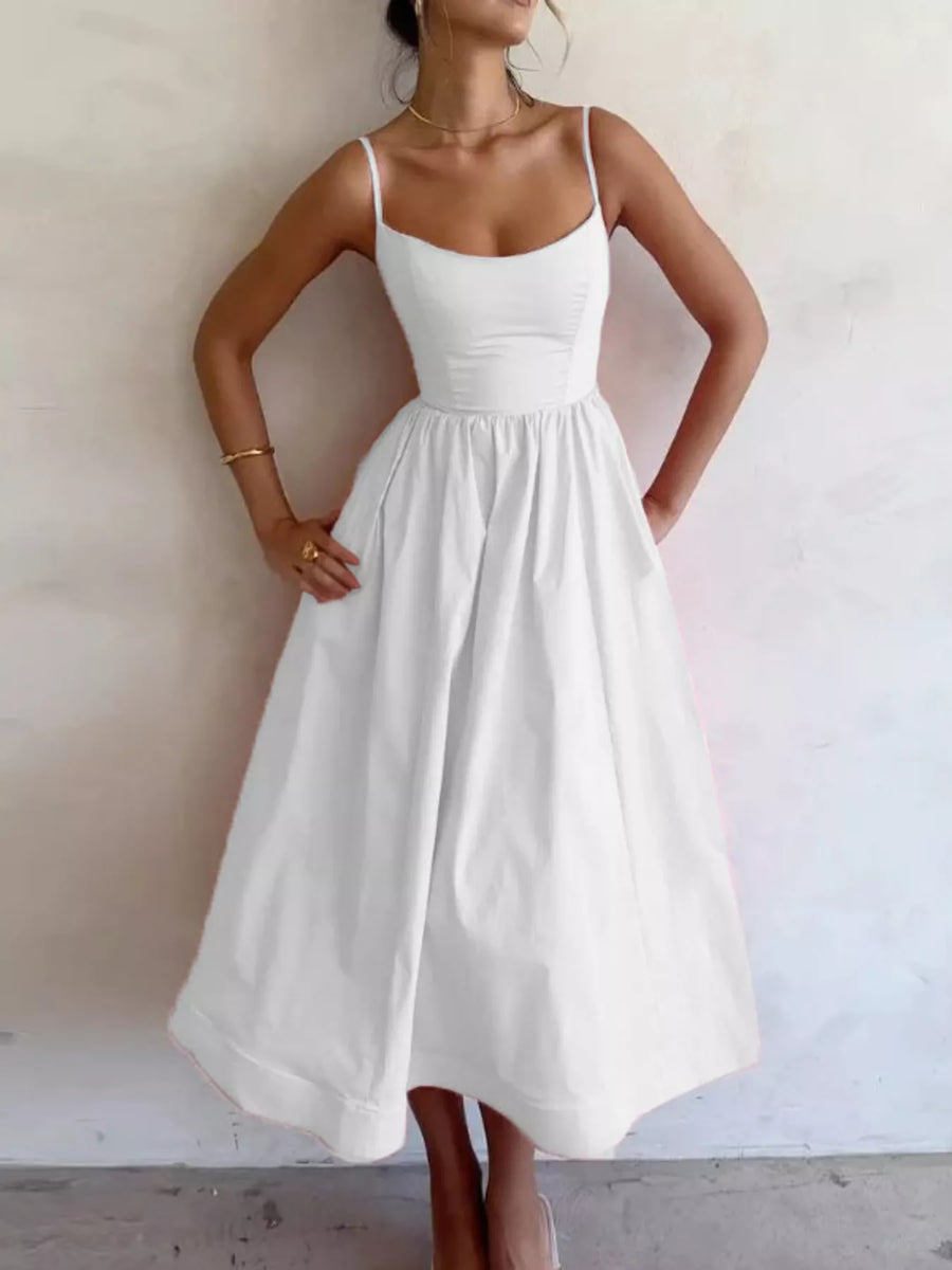 Woman wearing a white dress against a plain background