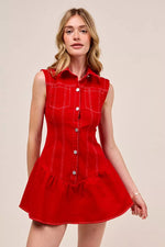 Woman wearing a red dress with white buttons on a beige background