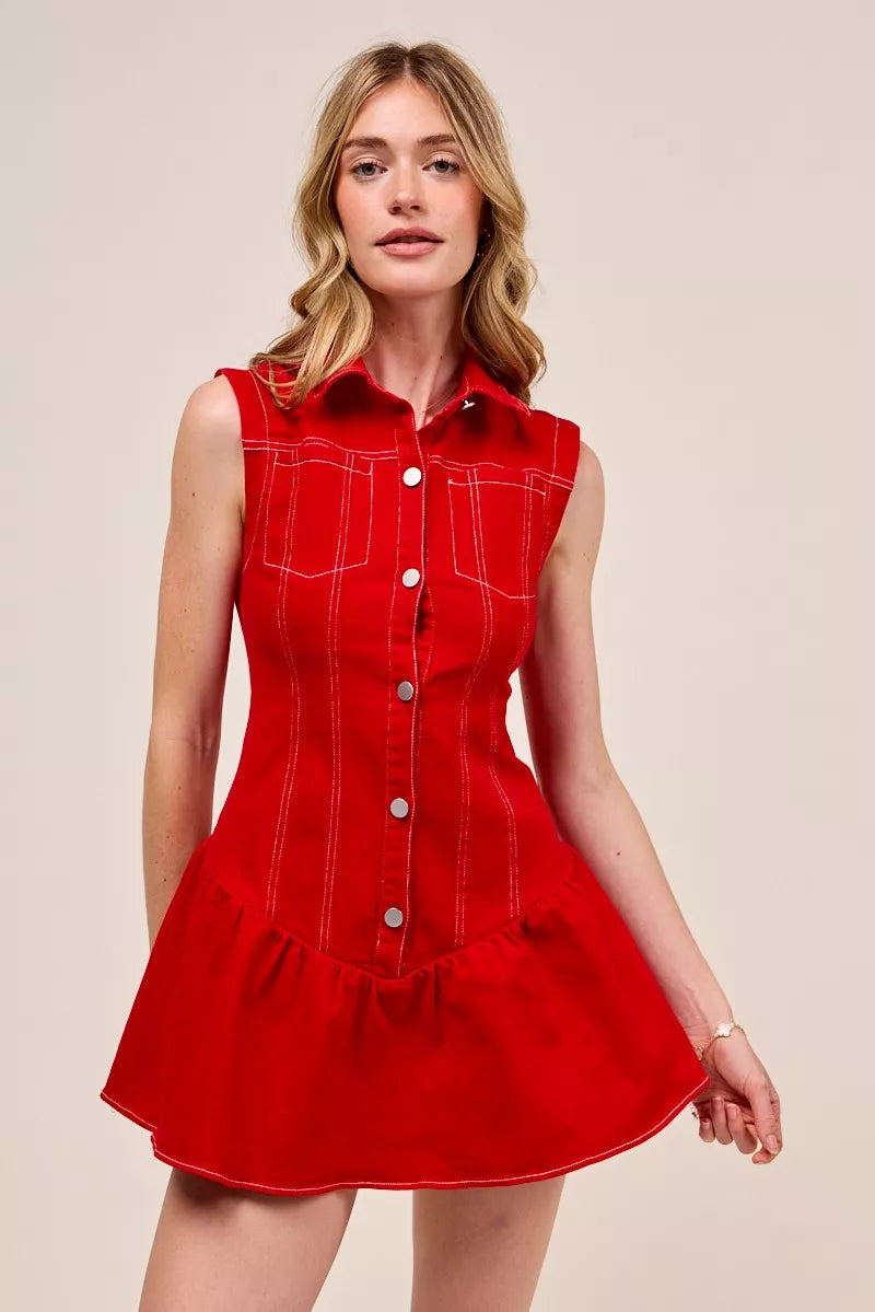 Woman wearing a red dress with white buttons on a beige background