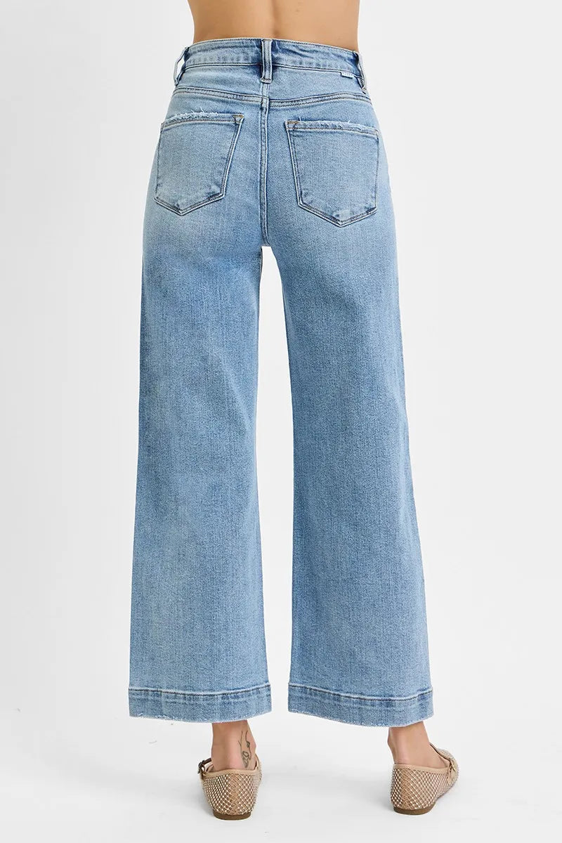 Light blue jeans worn by a person on a white background