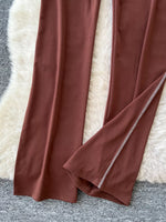 Brown fabric with a white border draped over a textured surface