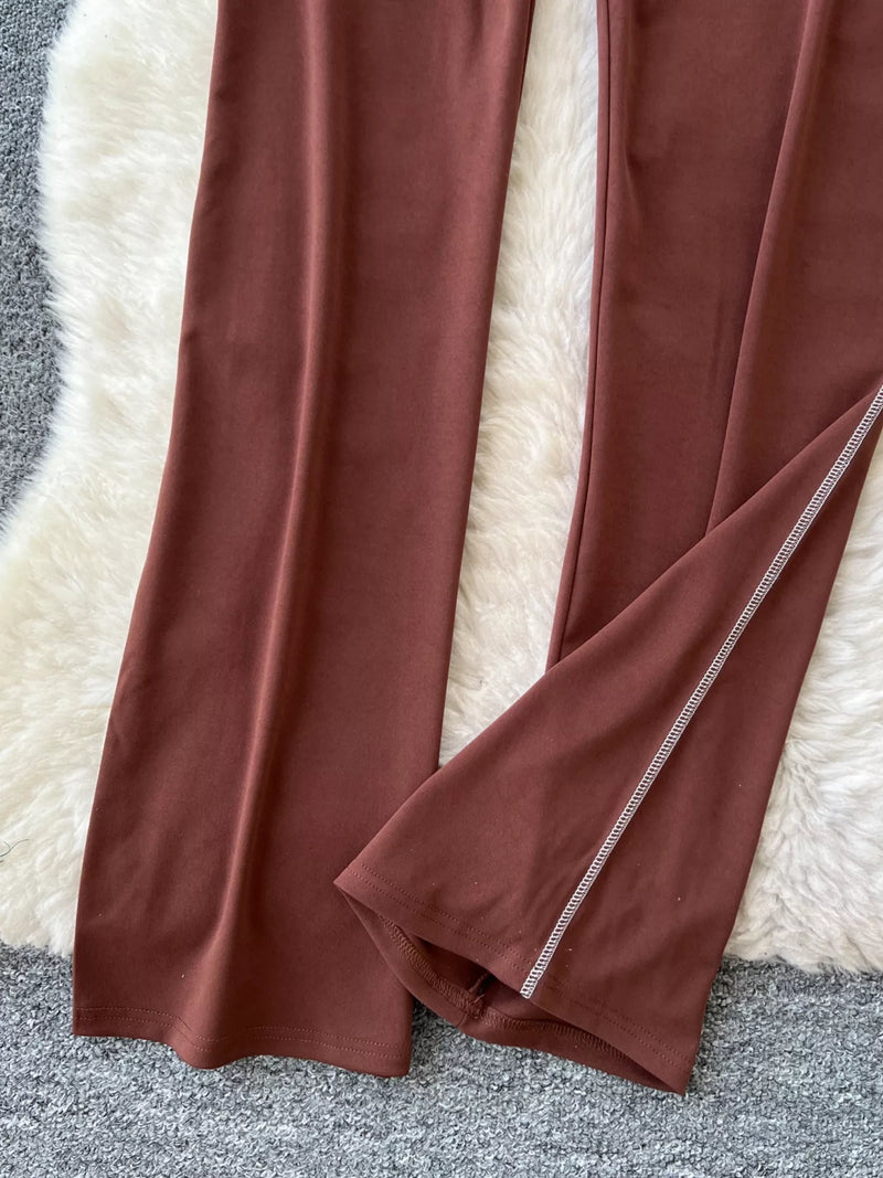 Brown fabric with a white border draped over a textured surface