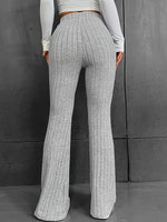 Person wearing gray ribbed wide-leg pants against a gray background