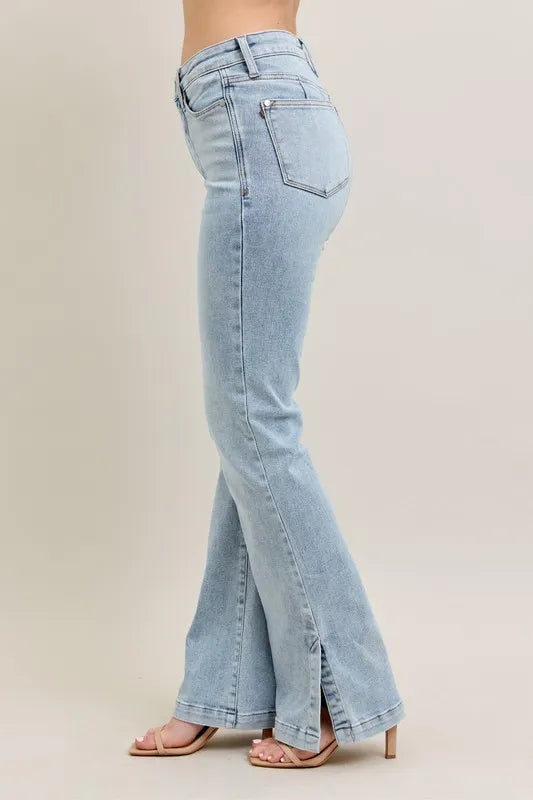 Light blue flared jeans on a neutral background