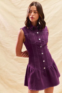 Woman wearing a purple dress against a beige background