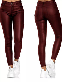 Maroon leather pants worn by a person on a white background