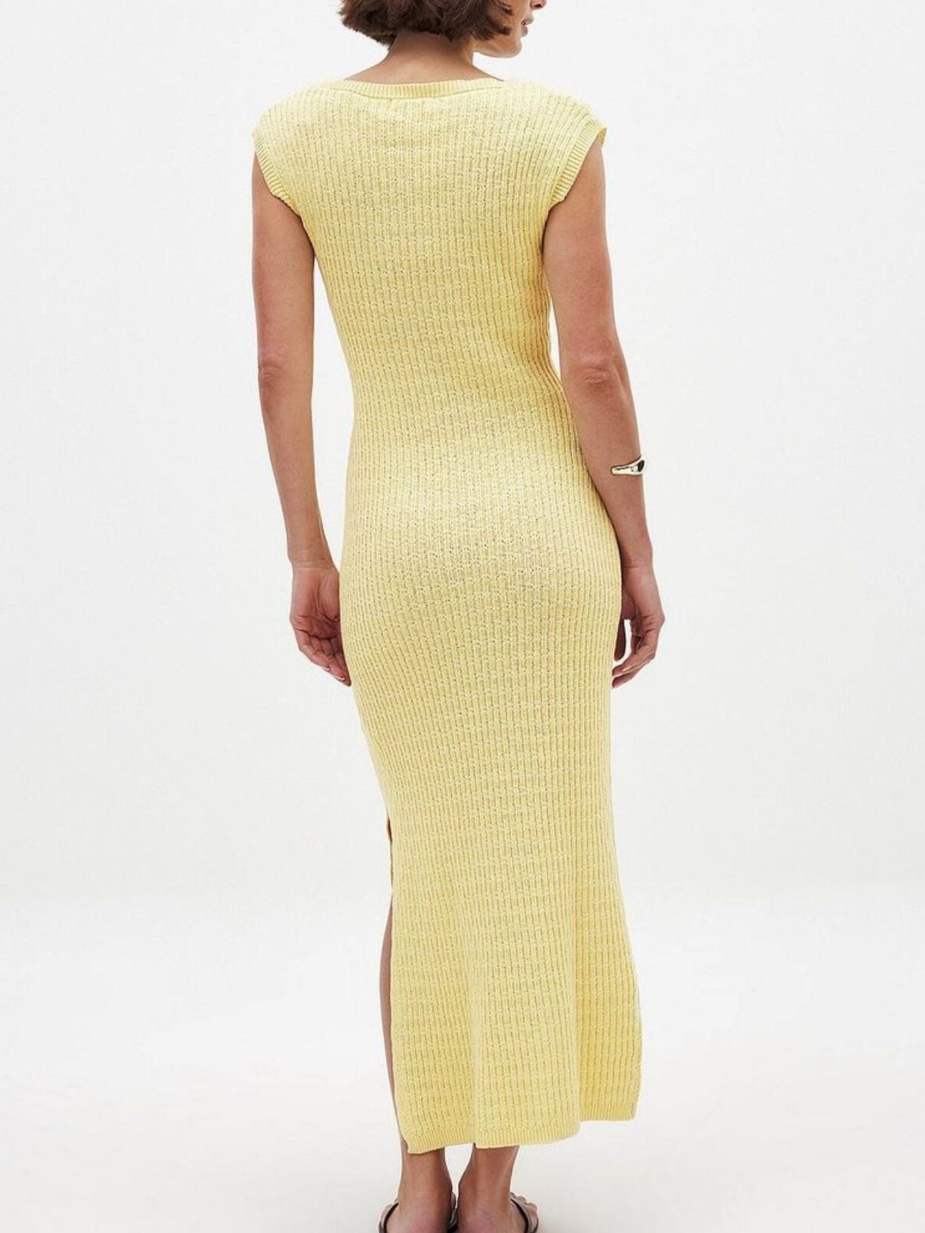 Yellow ribbed dress worn by a person on a white background