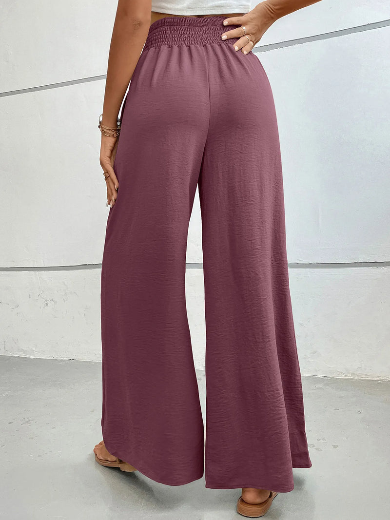 Person wearing mauve wide-leg pants against a neutral background