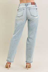 Light blue jeans worn by a person on a beige background