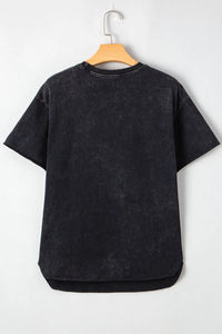 Black t-shirt on a wooden hanger against a white background