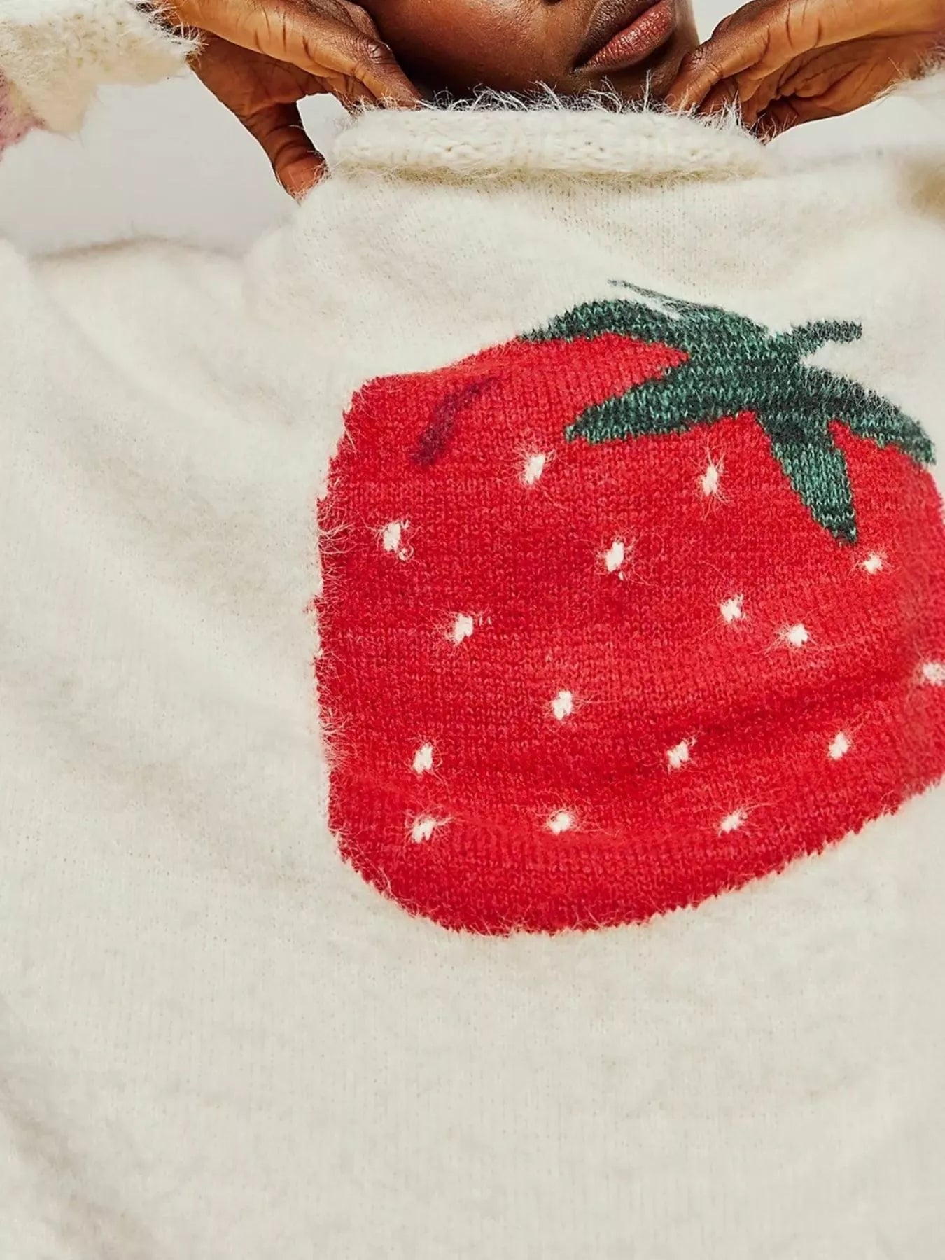Close-up of a textured red strawberry design on a beige fabric background