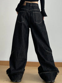 Black wide-leg jeans worn by a person on a plain background