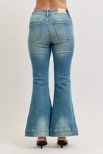 Blue flared jeans on a plain background