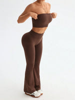 Person wearing brown high-waisted leggings and a matching crop top on a white background
