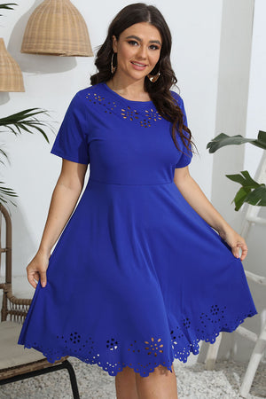 Woman wearing a blue dress with decorative elements in a home setting