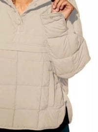 Beige quilted jacket with a focus on the chest area on a white background