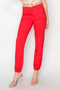Red pants worn by a person on a white background