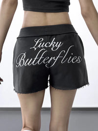Black shorts with 'Lucky Butterflies' text on a plain background