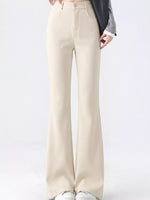 A person wearing high-waisted, straight-leg or bootcut pants in a light cream/beige color, styled with a gray cardigan and white sneakers against a plain white studio background.
