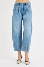 Light blue jeans worn by a person on a white background