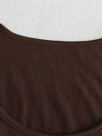 Close-up of brown fabric with a white textured background