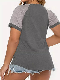 Gray and white baseball-style t-shirt worn by a person on a white background
