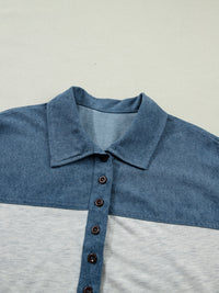 Close-up of a blue and gray polo shirt with a collar on a light gray background