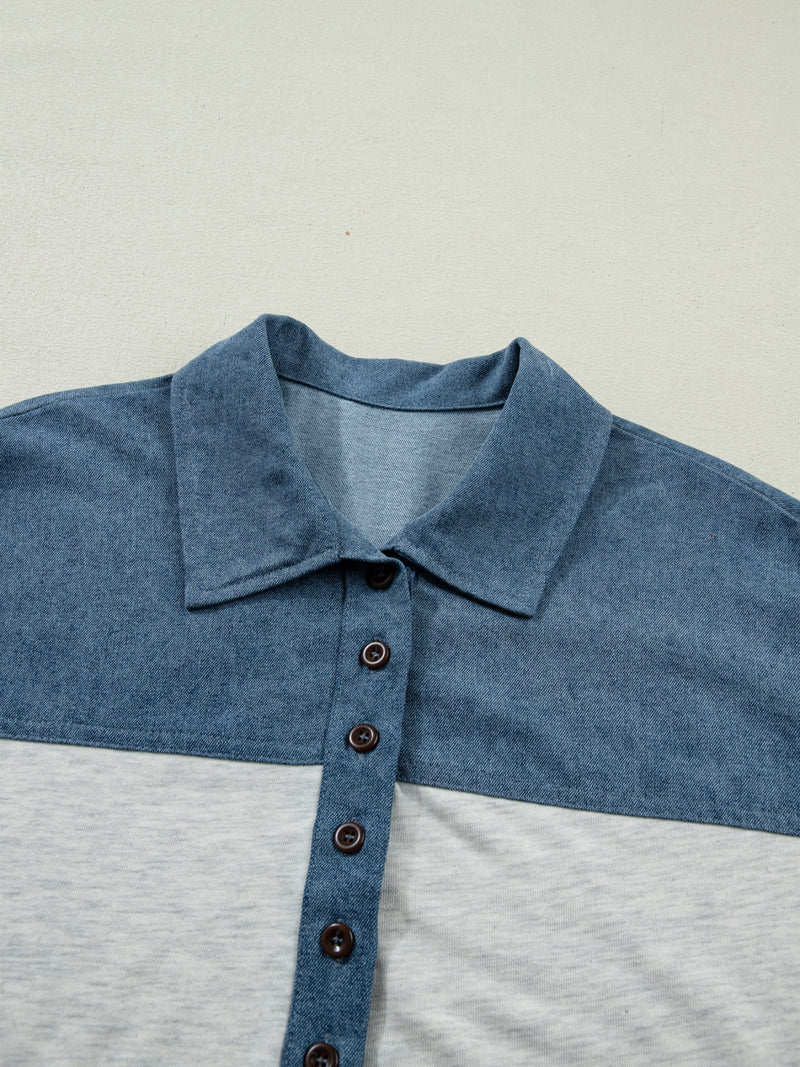 Close-up of a blue and gray polo shirt with a collar on a light gray background