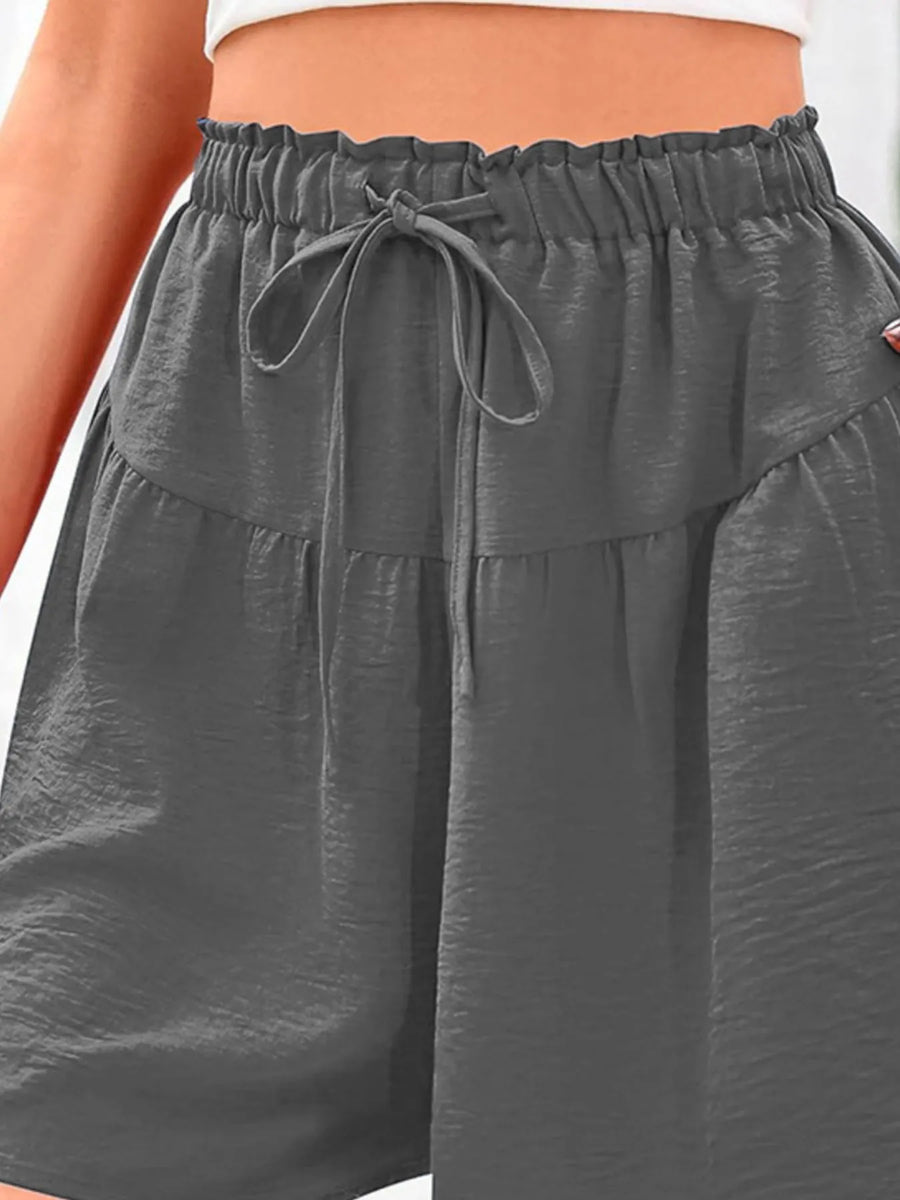 Gray wide-leg pants with an elastic waistband worn by a person.