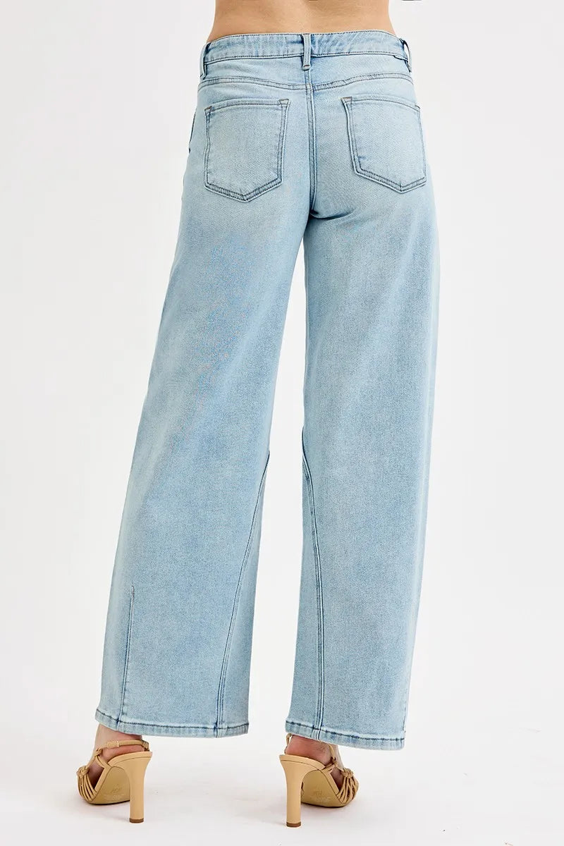 Light blue jeans worn by a person on a white background