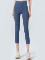 Person wearing blue leggings on a white background