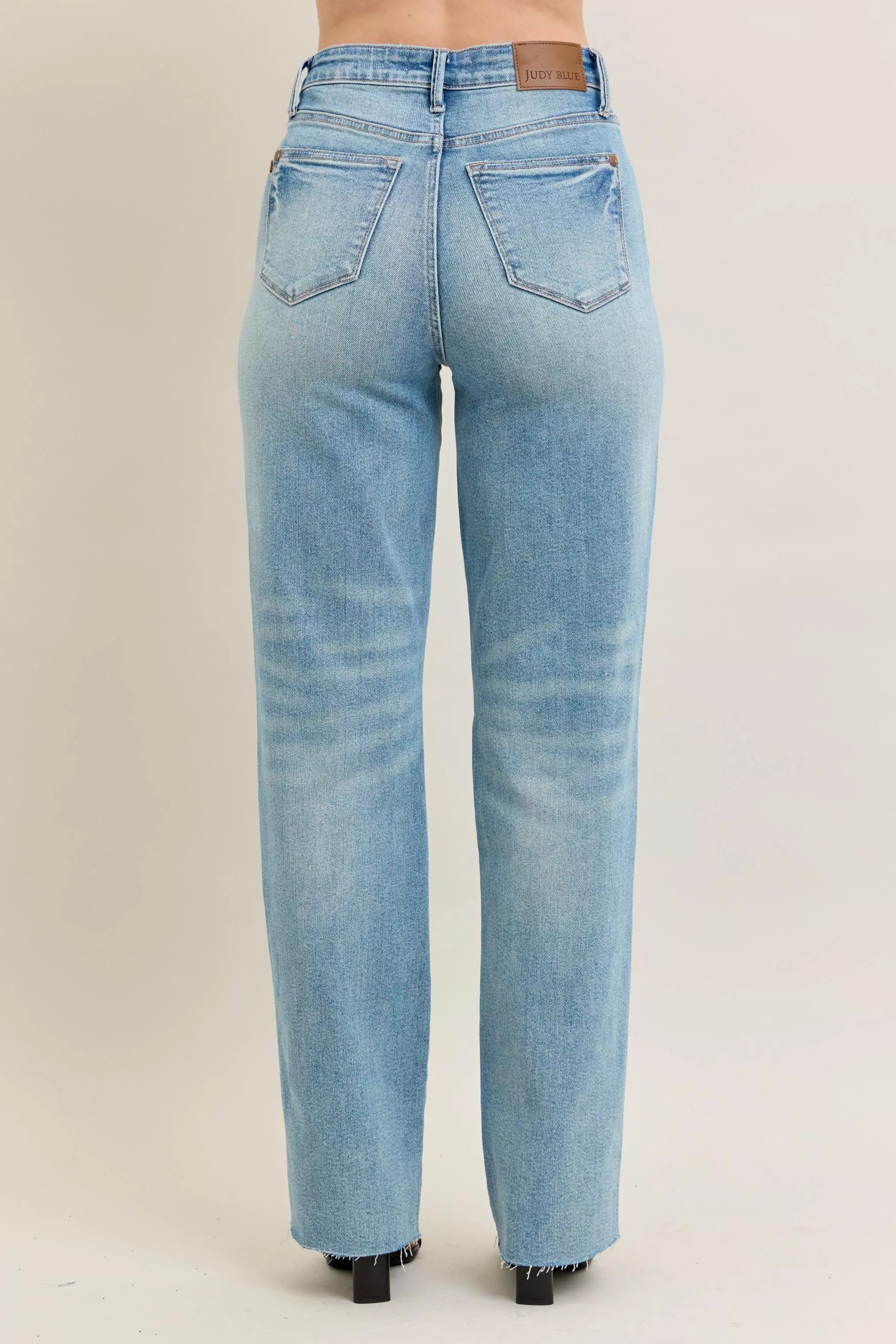 Light blue jeans on a beige background