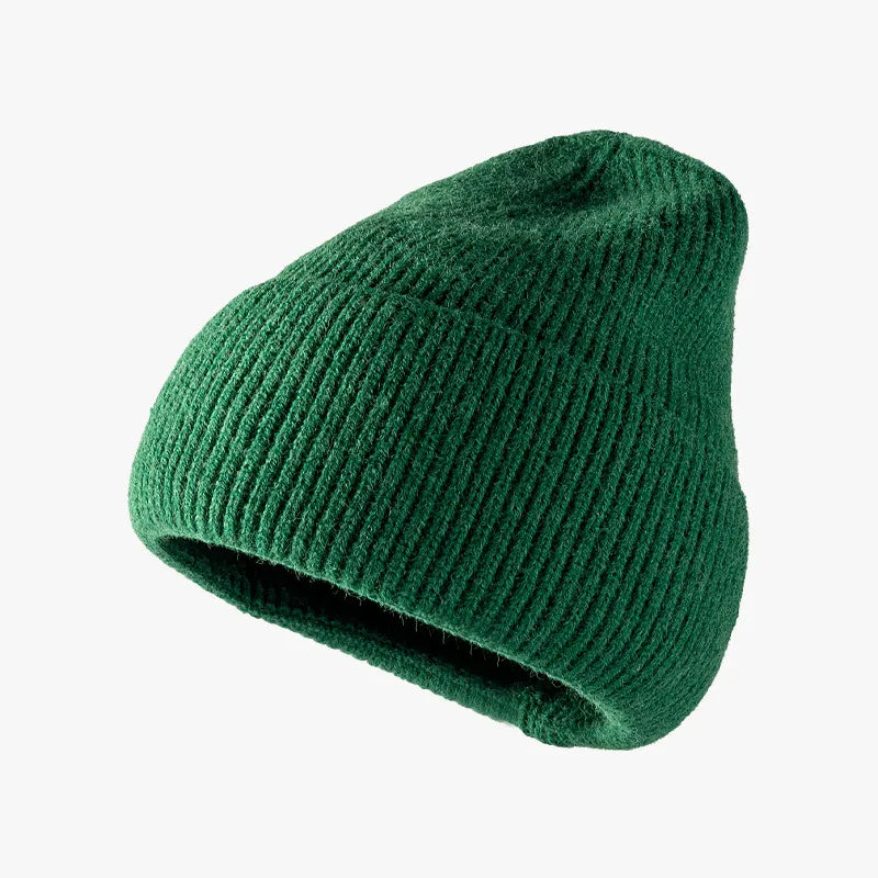 Green knit beanie on a white background
