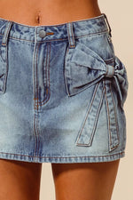 Denim skirt with a bow detail on a beige background