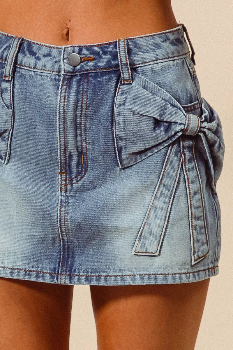 Denim skirt with a bow detail on a beige background