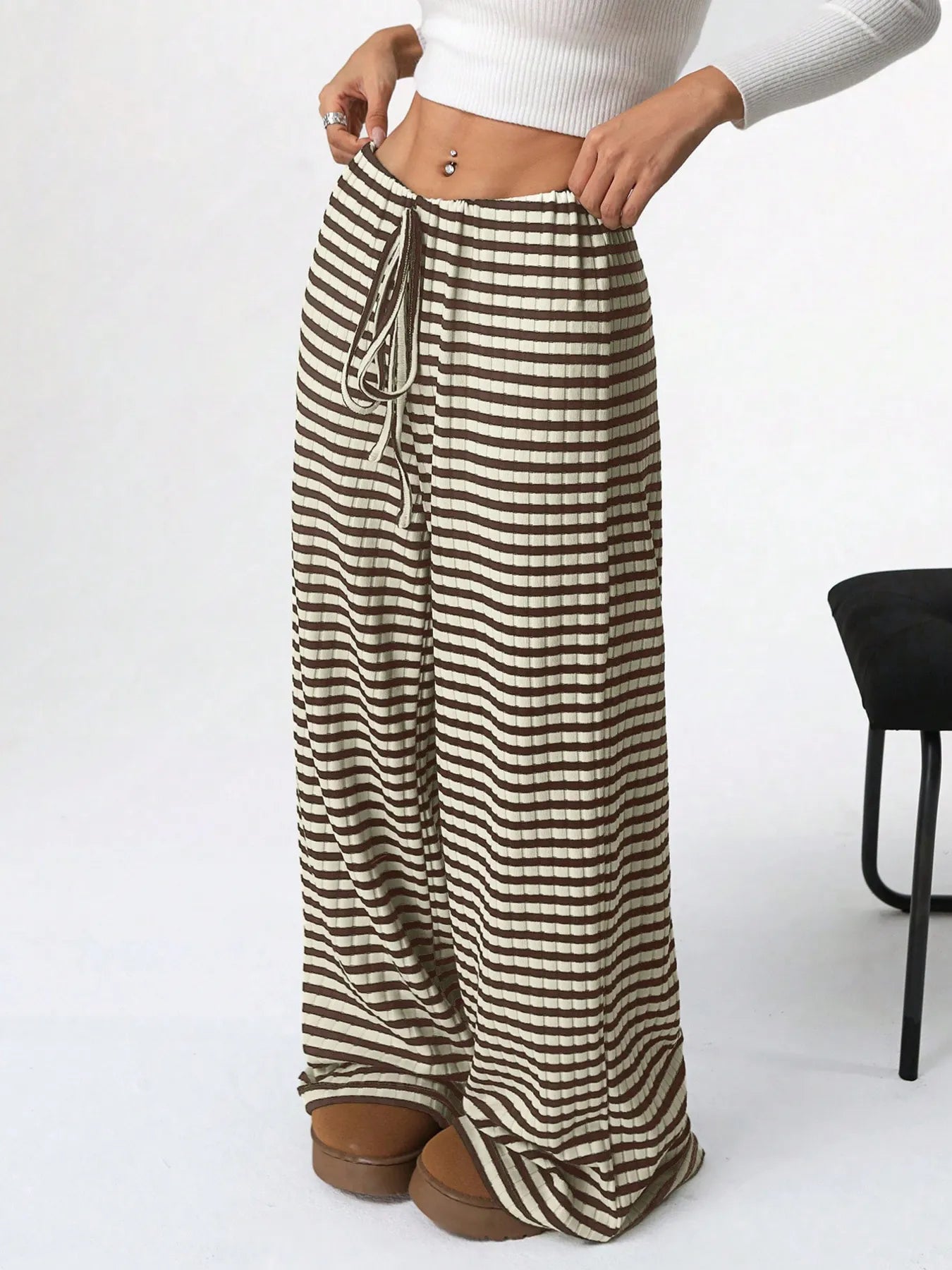 Striped pants worn by a person on a white background