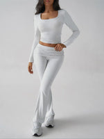 Person wearing a white long-sleeve top and pants on a gray background