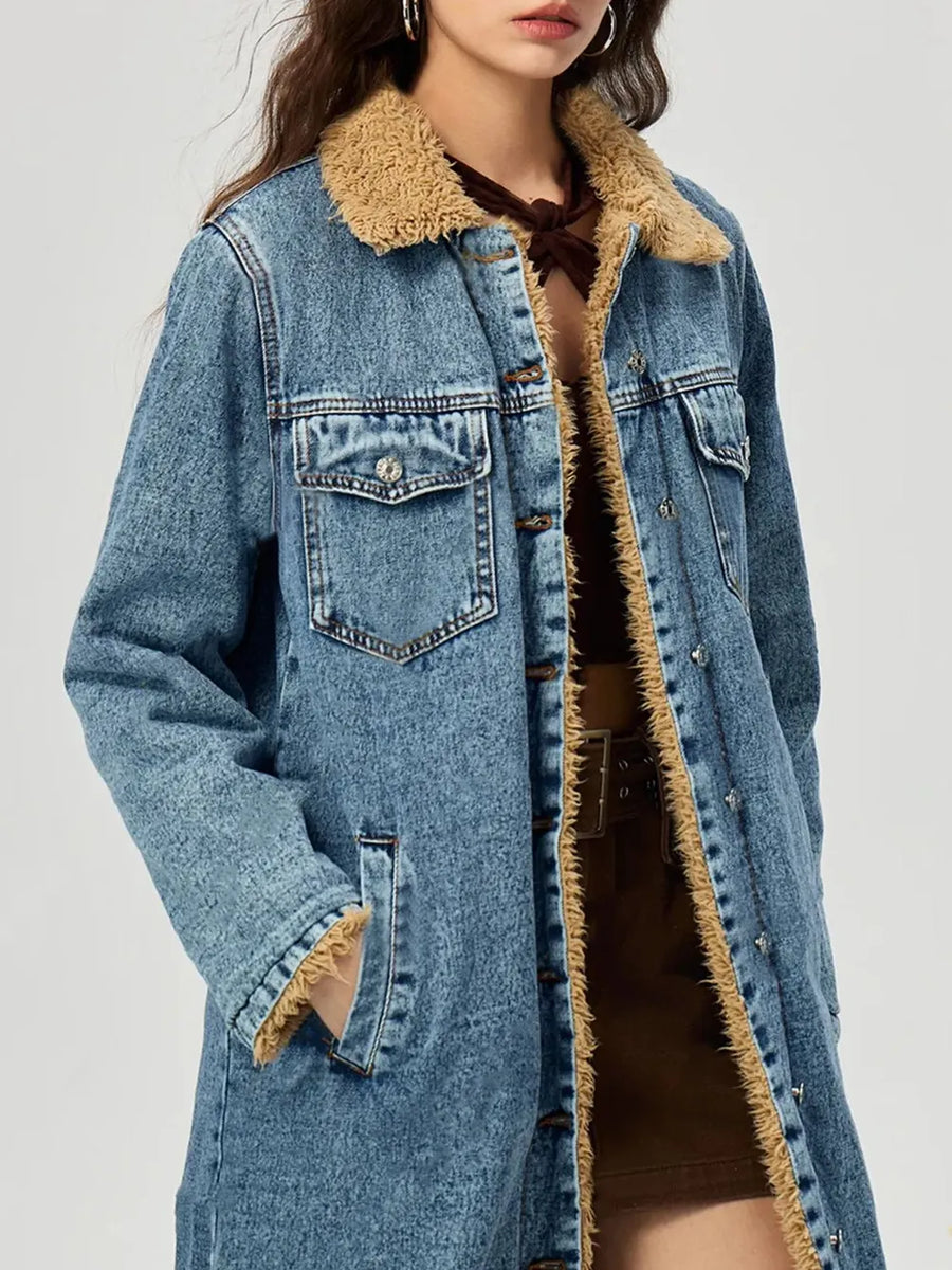 Blue denim jacket with beige sherpa lining on a white background