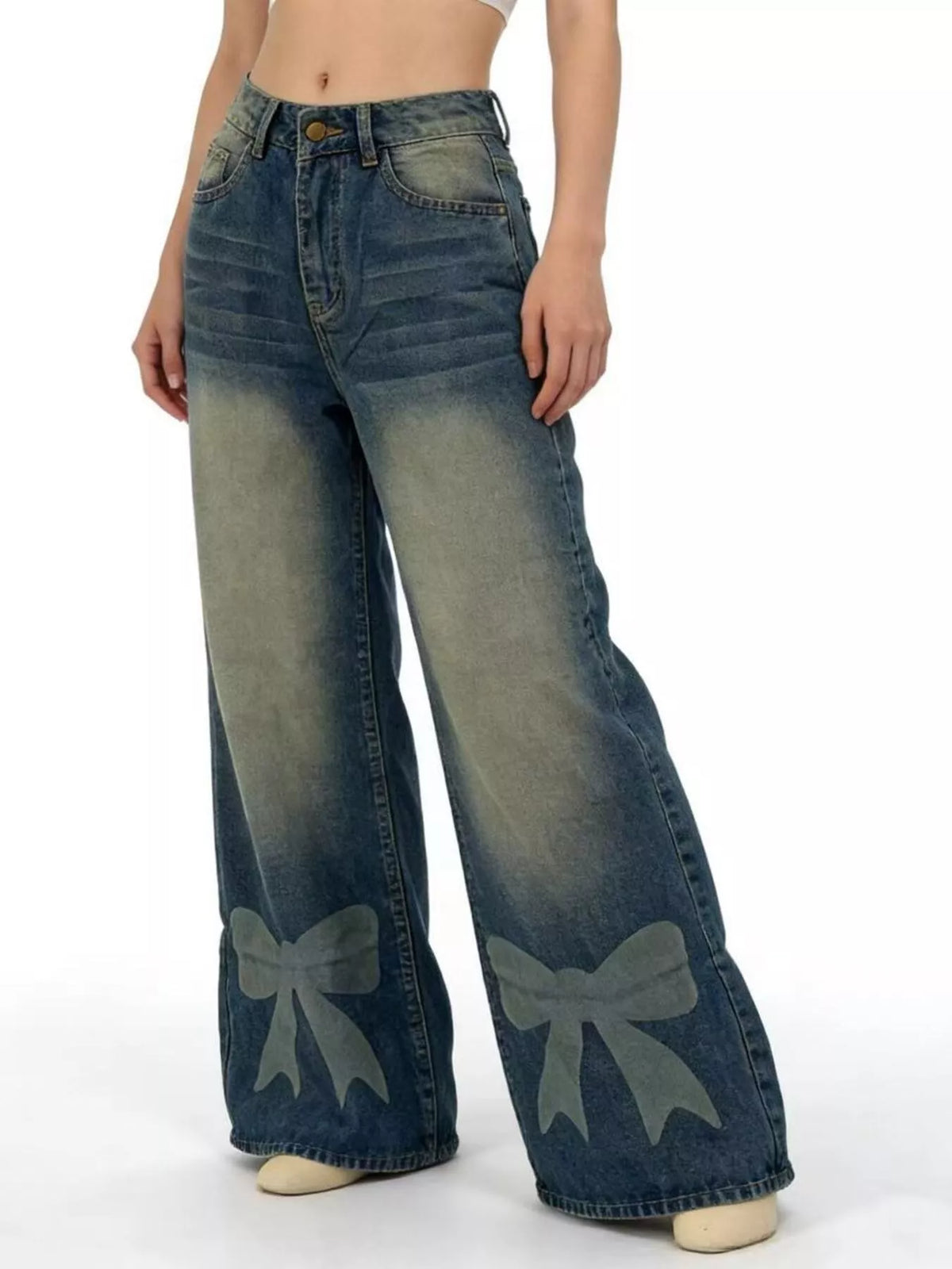 Blue jeans with bow designs on a white background
