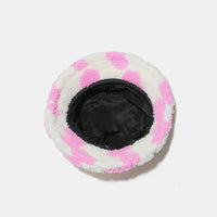 Round plush toy with pink and white checkered pattern on a white background