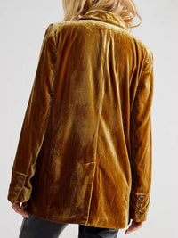 Brown velvet jacket worn by a person on a white background