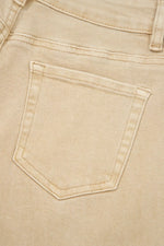 Close-up of a beige denim pocket