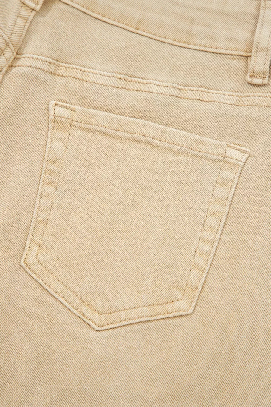 Close-up of a beige denim pocket