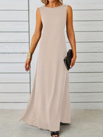 Woman wearing a long beige dress against a wooden background
