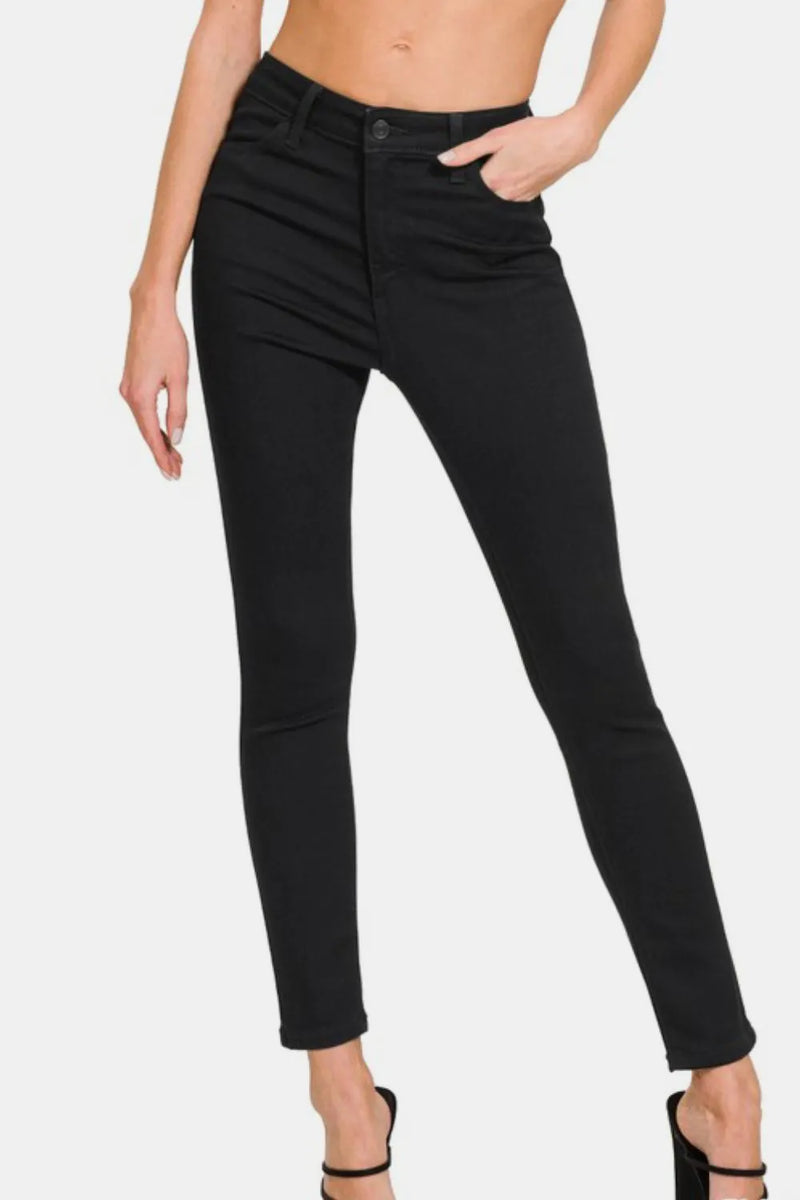 Black jeans worn by a person on a white background