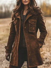 Person wearing a brown leather coat standing in a field.