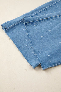 Close-up of blue denim fabric on a beige background