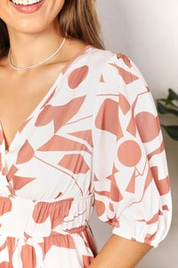 Woman wearing a white dress with red floral pattern indoors