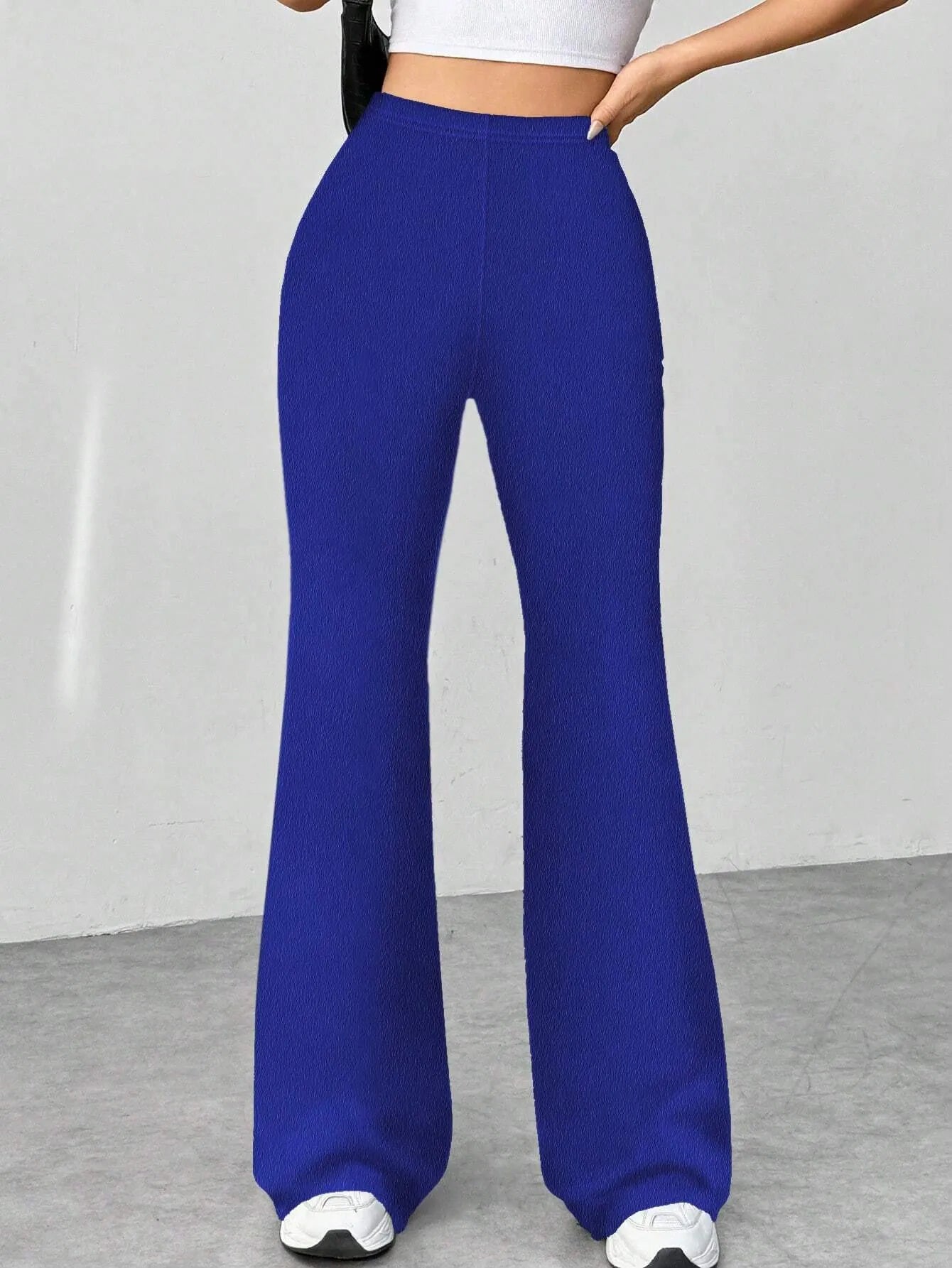 Blue wide-leg pants worn by a person on a plain background